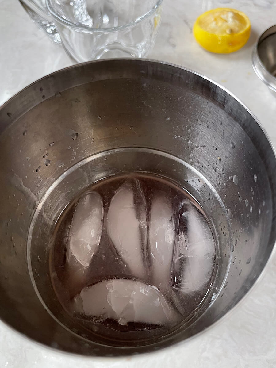 st. germain cocktail with cranberry juice vodka and lemon in a drink shaker