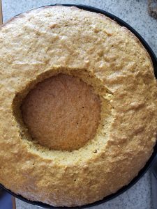 cutting a second hole in the surprise carrot cake to fill with the chocolate covered eggs and almonds
