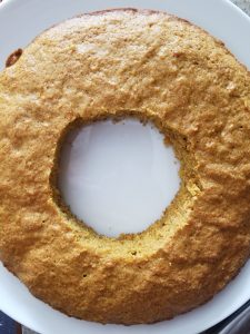 a circle cut in the center of 1 of the layers of the surprise carrot cake
