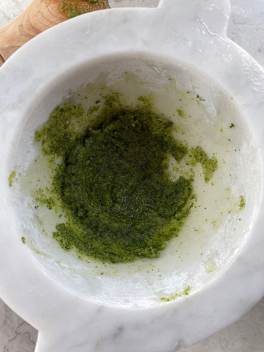 finely smashed mint leaves in a mortar