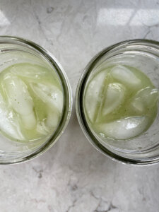 ice cubes added to mojito glass