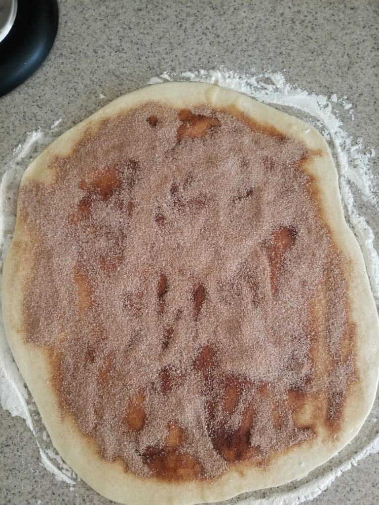 cinnamon sugar mixture added to the cinnamon roll dough