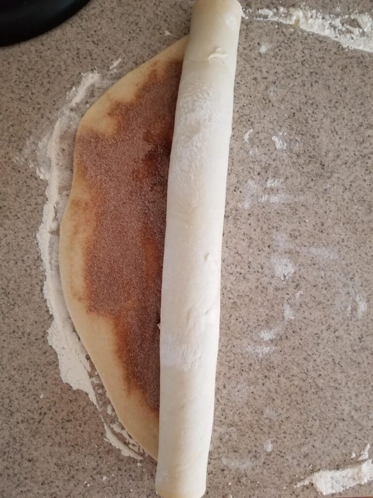 rolling the cinnamon rolls up